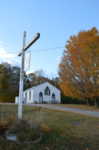 A well-kept church sits across the road from the cemetery. 